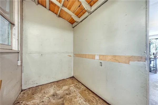a front view of a house with a garden and tree