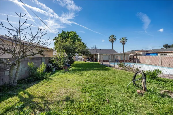 a view of a porch with chairs and potted plants