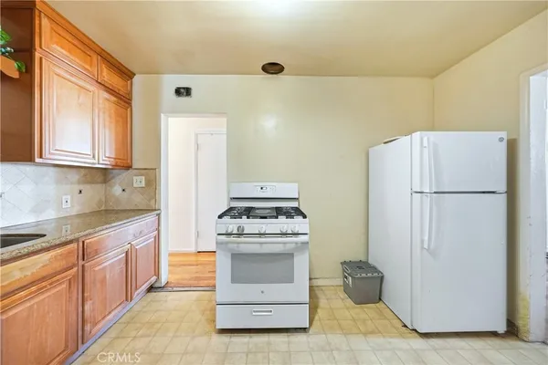 a kitchen with a stove sink and refrigerator