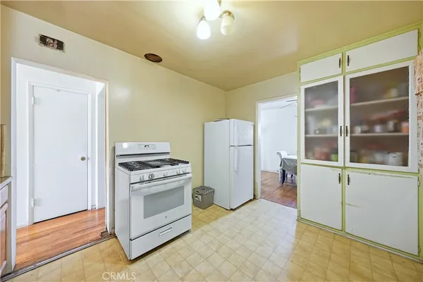 a kitchen with a stove and a refrigerator