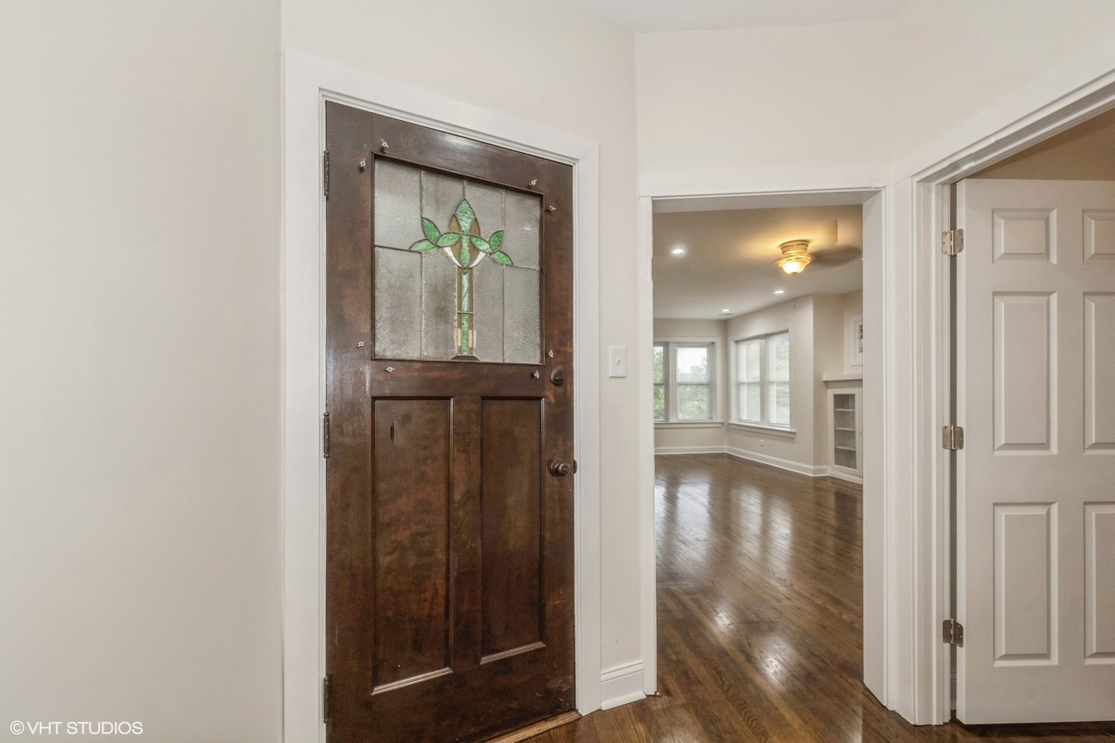 5029 West Washington Boulevard, Unit 1E Chicago, IL 60644 - Photo 11 of 26 an empty room with wooden floor mirror and windows