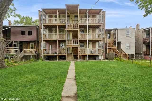 a front view of a building with a yard