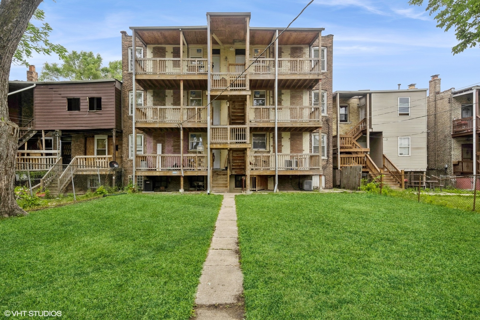 5029 West Washington Boulevard, Unit 1E Chicago, IL 60644 - Photo 22 of 26 a front view of a building with a yard