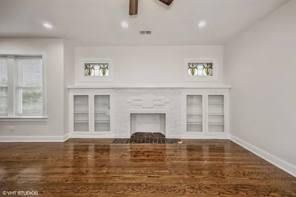 a view of pool a chandelier and wooden floor