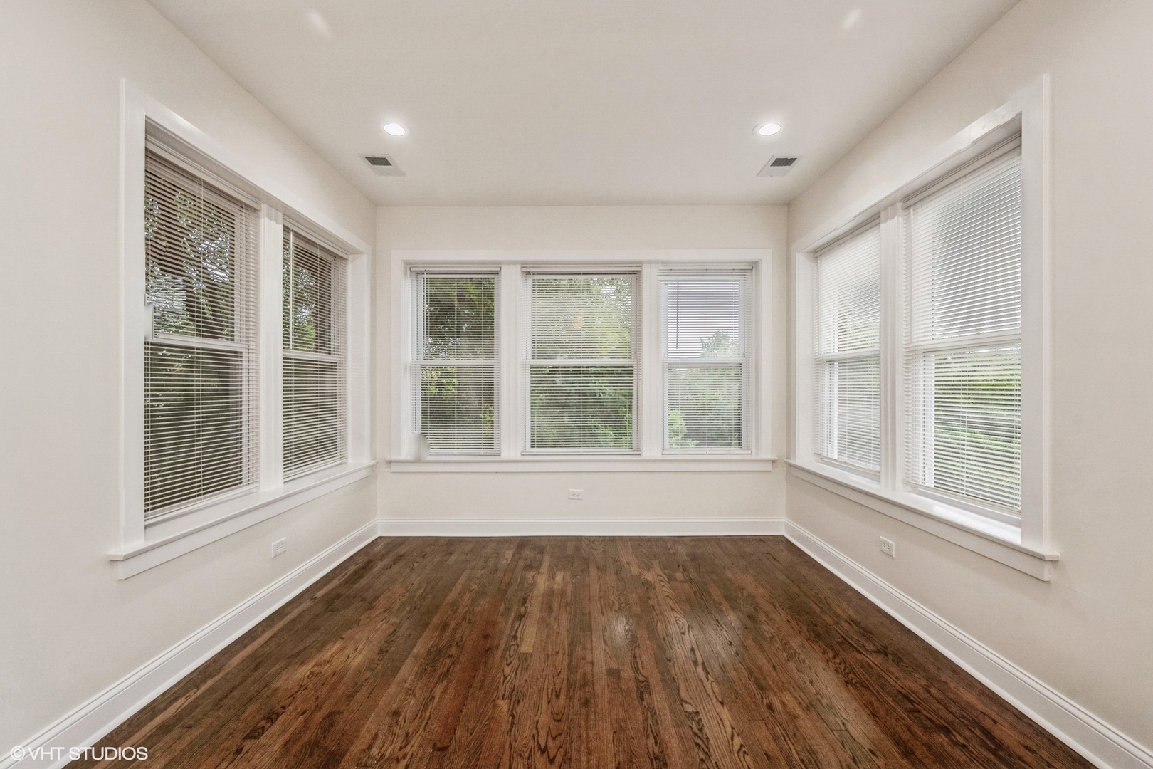 5029 West Washington Boulevard, Unit 1E Chicago, IL 60644 - Photo 7 of 26 a view of an empty room with wooden floor and a window