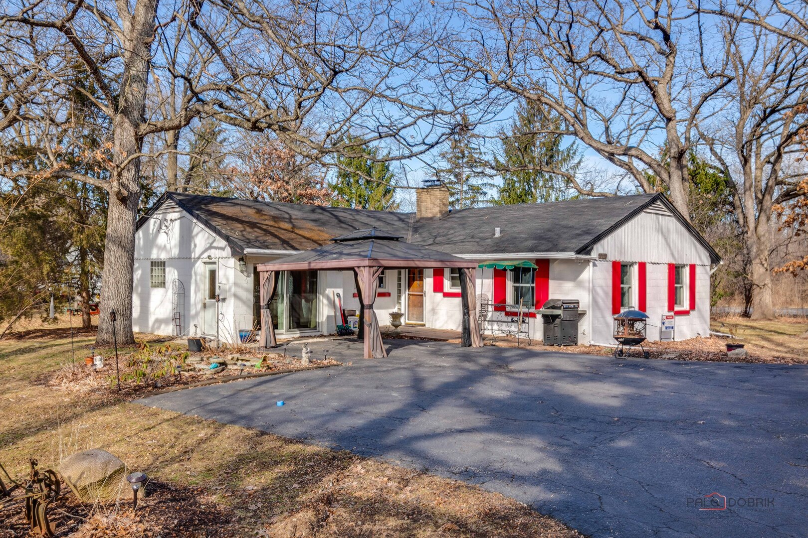 15983 West Wadsworth Road Wadsworth, IL 60083 - Photo 1 of 32 a view of large building with large trees and wooden fence