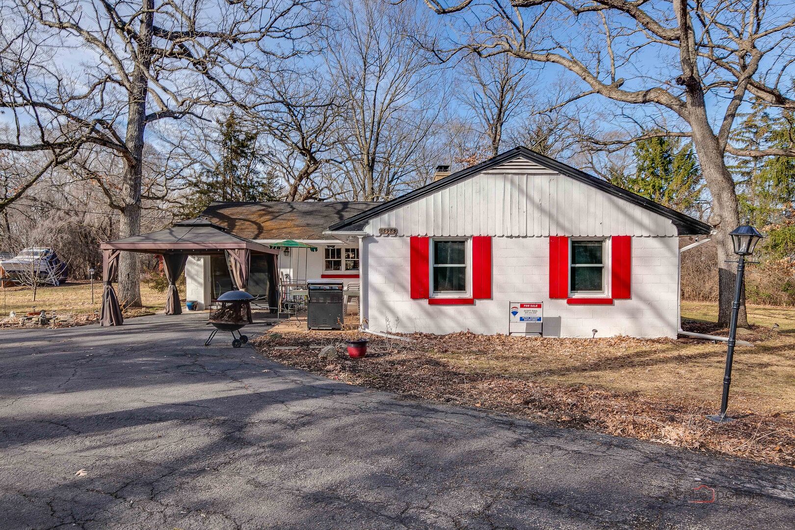 15983 West Wadsworth Road Wadsworth, IL 60083 - Photo 22 of 32 a view of a white house with a small yard and large tree