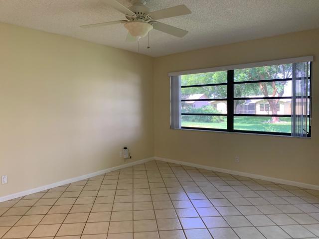 18065 Park Terrace Boca Raton, FL 33498 - Photo 7 of 20 an empty room with windows and fan