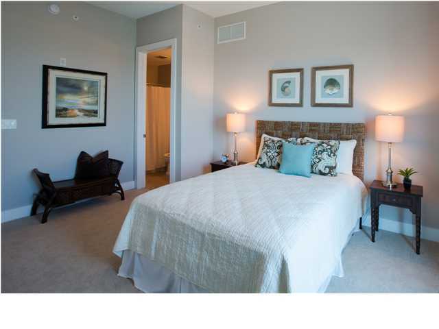 211 Durango Road, Unit 713 Destin, FL 32541 - Photo 16 of 30 a bedroom with a bed a table and painting on the wall