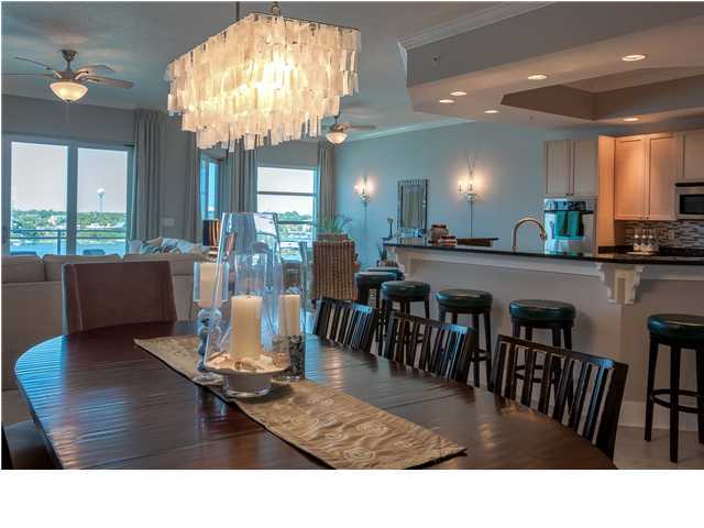 211 Durango Road, Unit 713 Destin, FL 32541 - Photo 7 of 30 a living room with kitchen island dining table and a chandelier