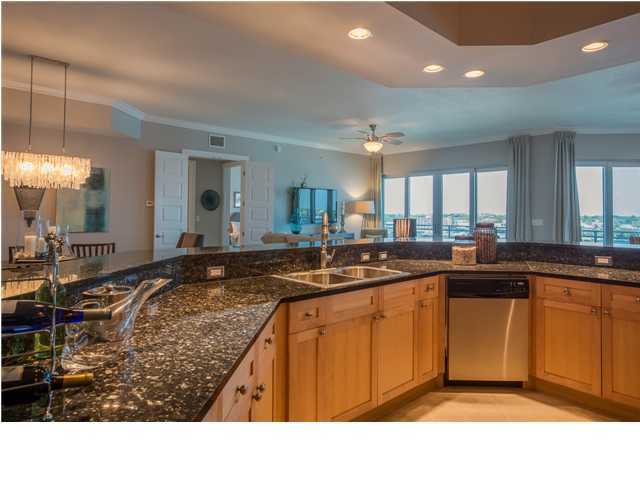 211 Durango Road, Unit 713 Destin, FL 32541 - Photo 9 of 30 a kitchen with stainless steel appliances granite countertop a sink counter space and a large window