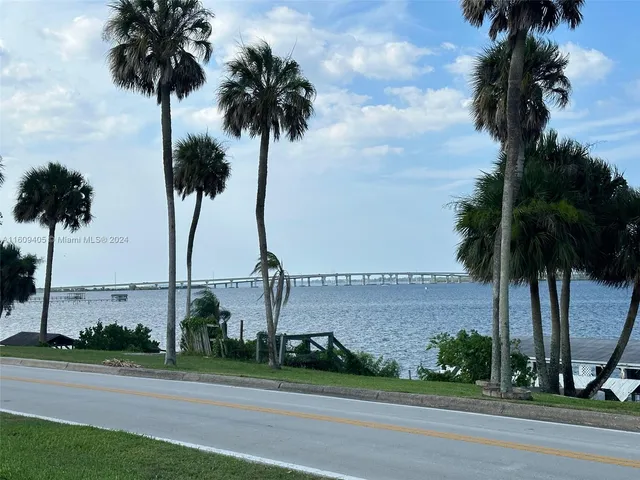 a kitchen with stainless steel appliances granite countertop a refrigerator a sink and a stove