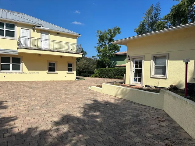 a bathroom with a double vanity sink a toilet and a shower