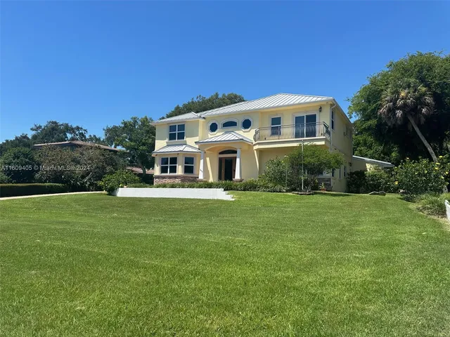 an aerial view of a house with outdoor space lake view and mountain view