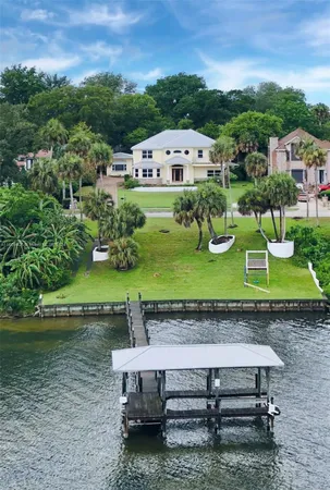 a view of a house with pool and sitting area