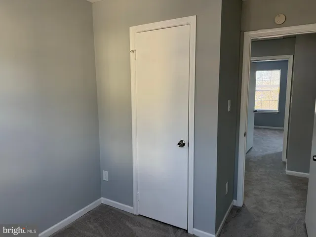 a small space with wooden floor and a hallway