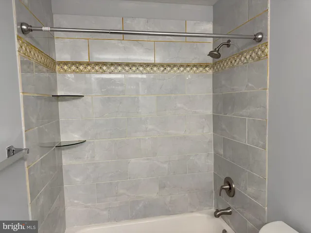 a bathroom with a shower and a sink