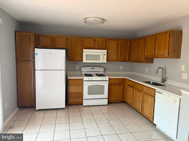 a kitchen with a stove a refrigerator and a sink