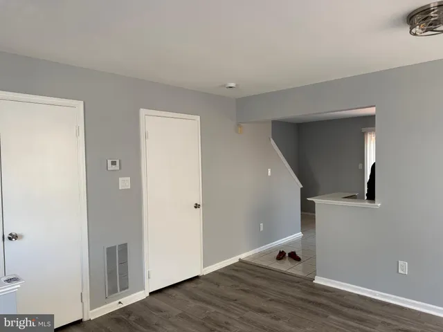 a view of room with stairs and wooden floor