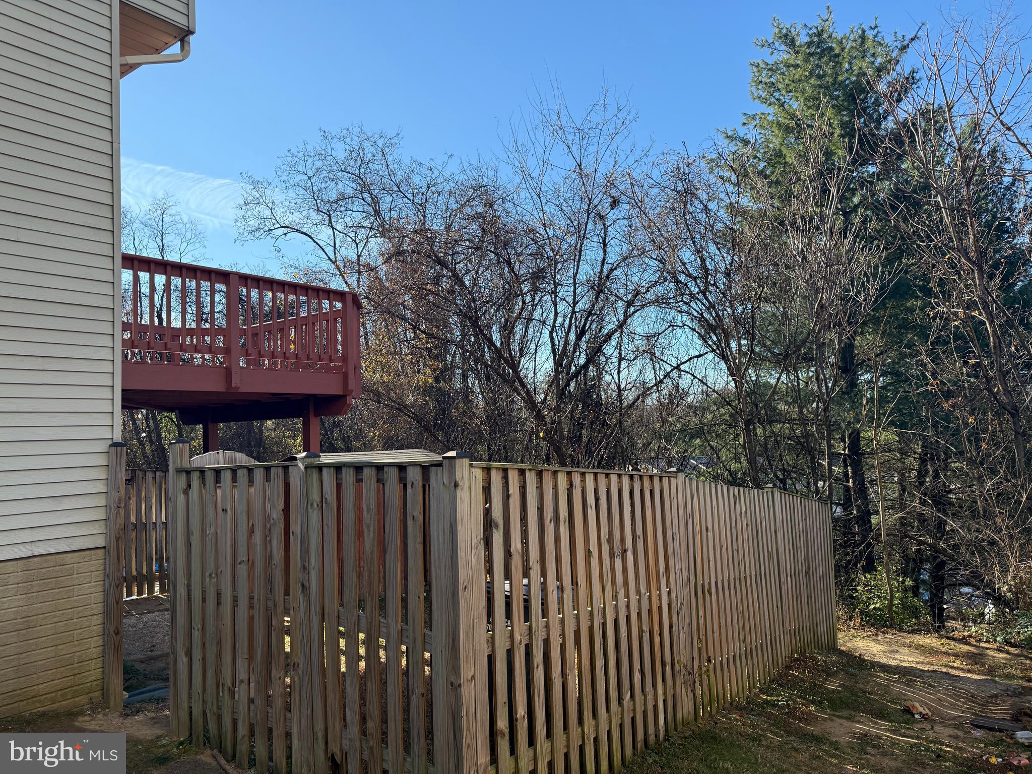 1935 Winslow Court Woodbridge, VA 22191 - Photo 33 of 34 a view of a brick house with a large window and wooden fence
