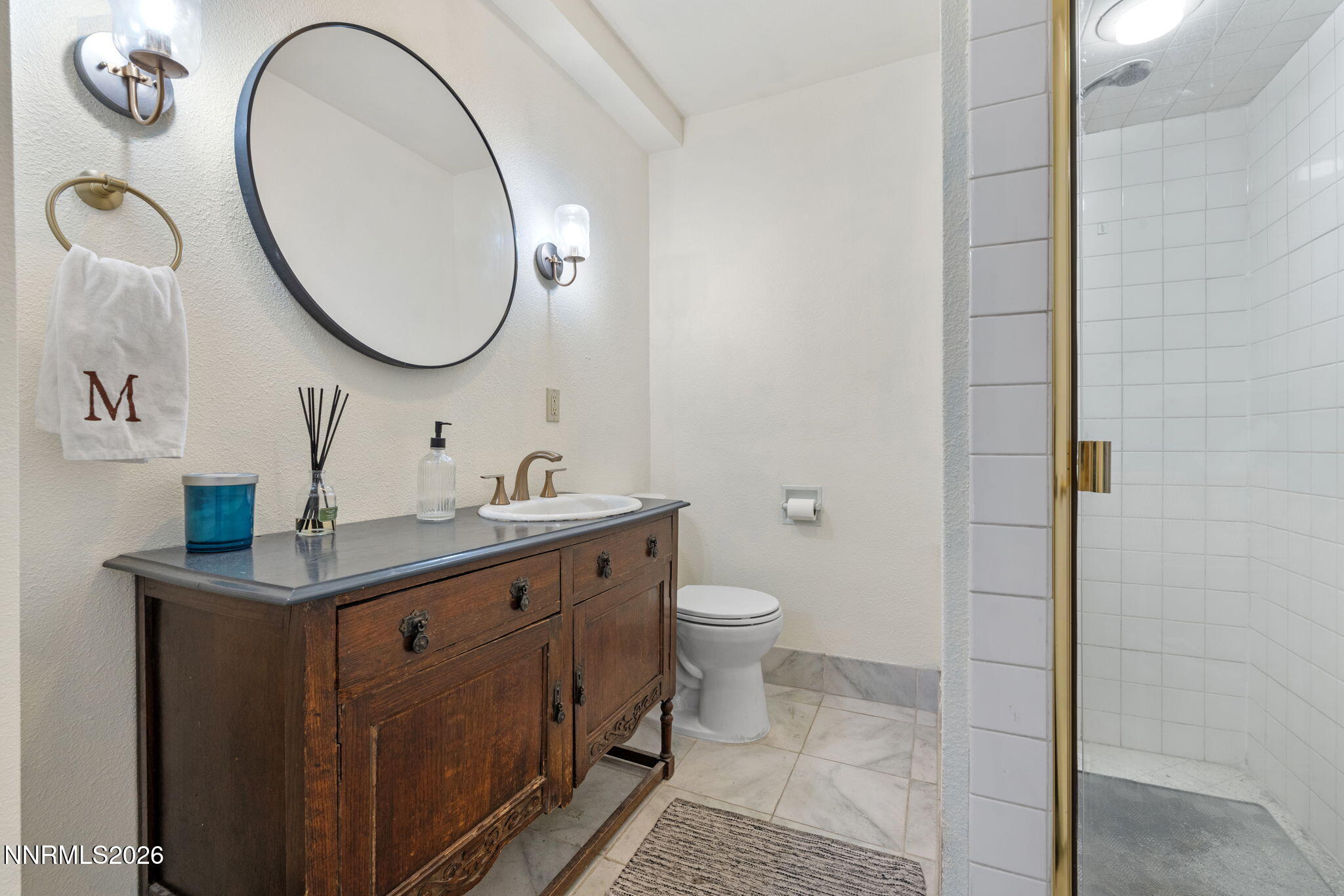 300 Country Club Drive Reno, NV 89509 - Photo 32 of 48 a bathroom with a toilet a sink and a mirror