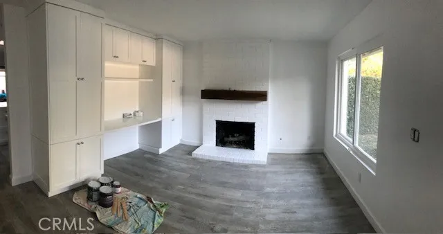 a spacious bedroom with a bed and wooden floor