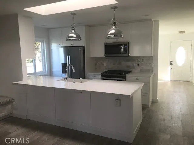 a bathroom with a washing machine and a shower