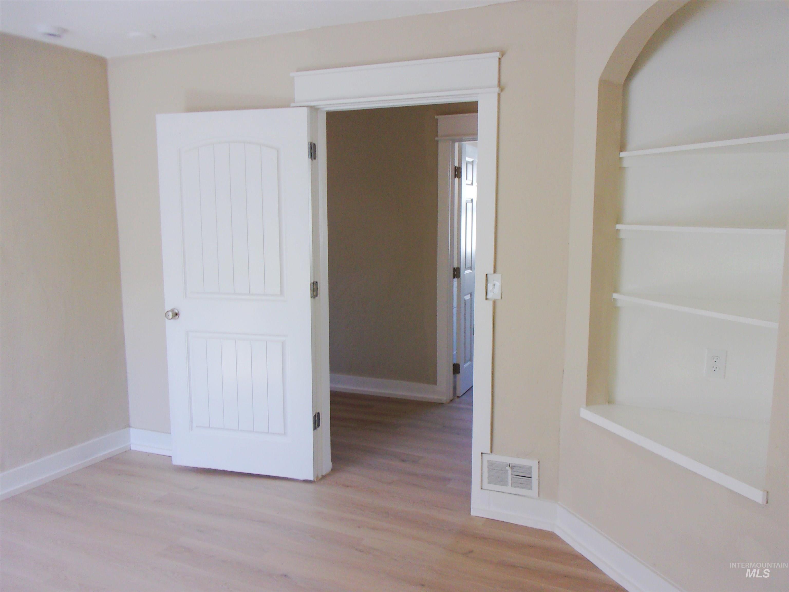 605 North 6th Street Parma, ID 83660 - Photo 30 of 46 Spare room featuring light wood-type flooring and arched walkways