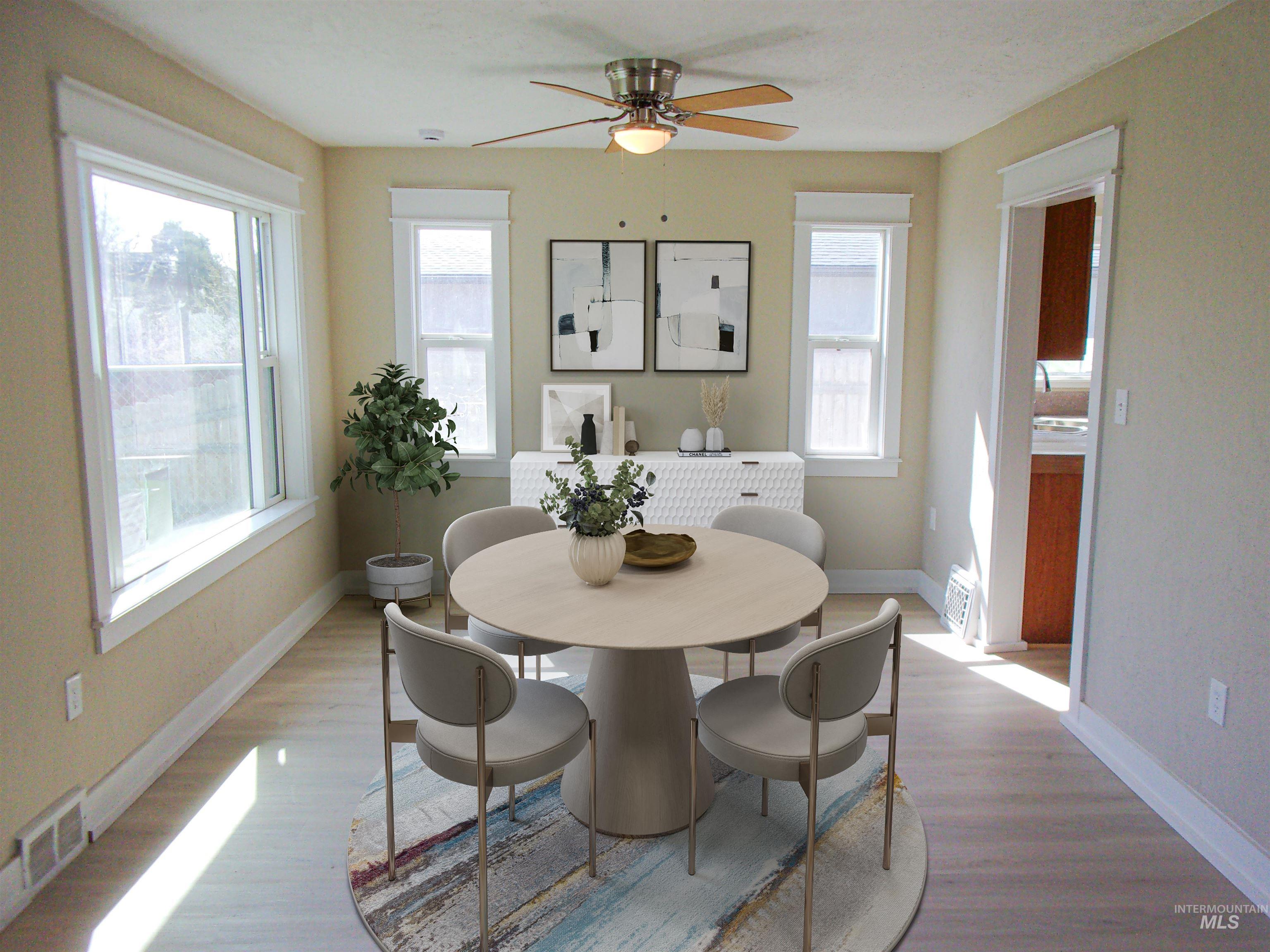 605 North 6th Street Parma, ID 83660 - Photo 37 of 46 Dining space featuring wood finished floors, a ceiling fan, and plenty of natural light