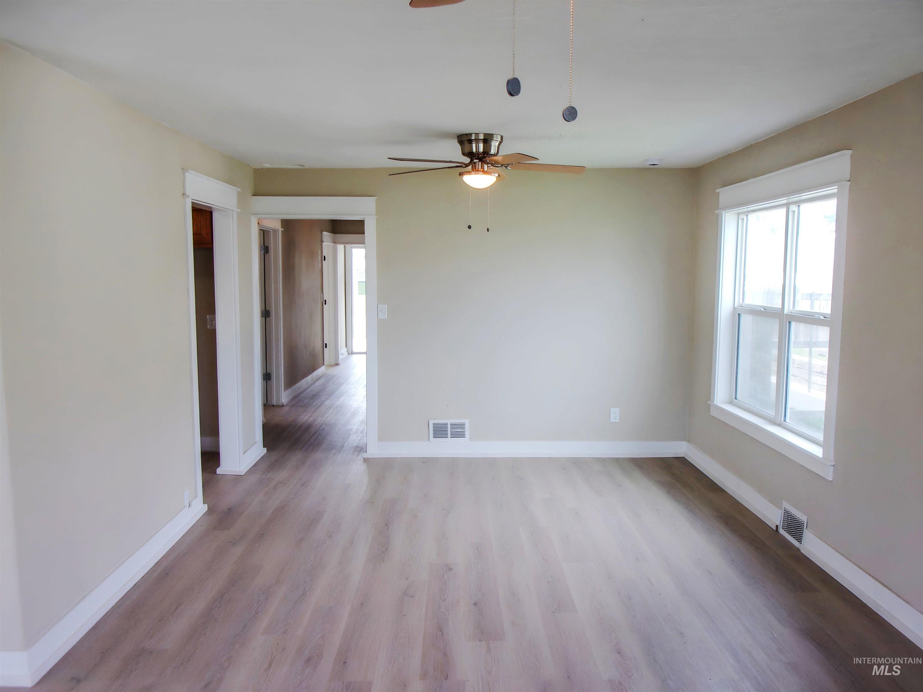 605 North 6th Street Parma, ID 83660 - Photo 7 of 46 Empty room with light wood-style flooring and a ceiling fan