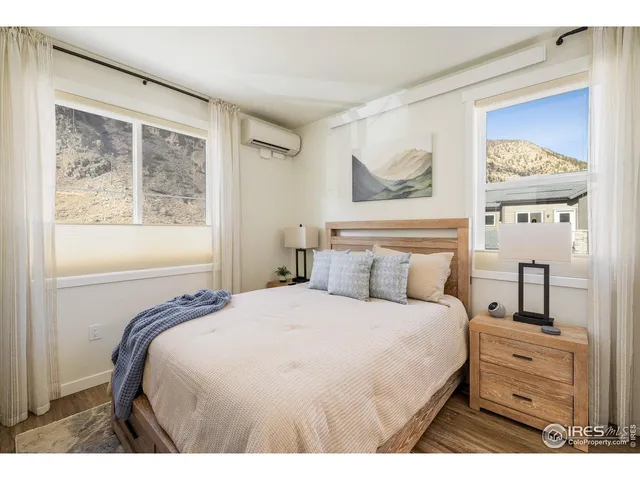 a bedroom with a bed and a painting on the wall