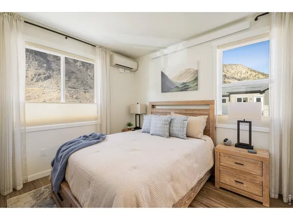 a bedroom with a large bed and a flat tv screen