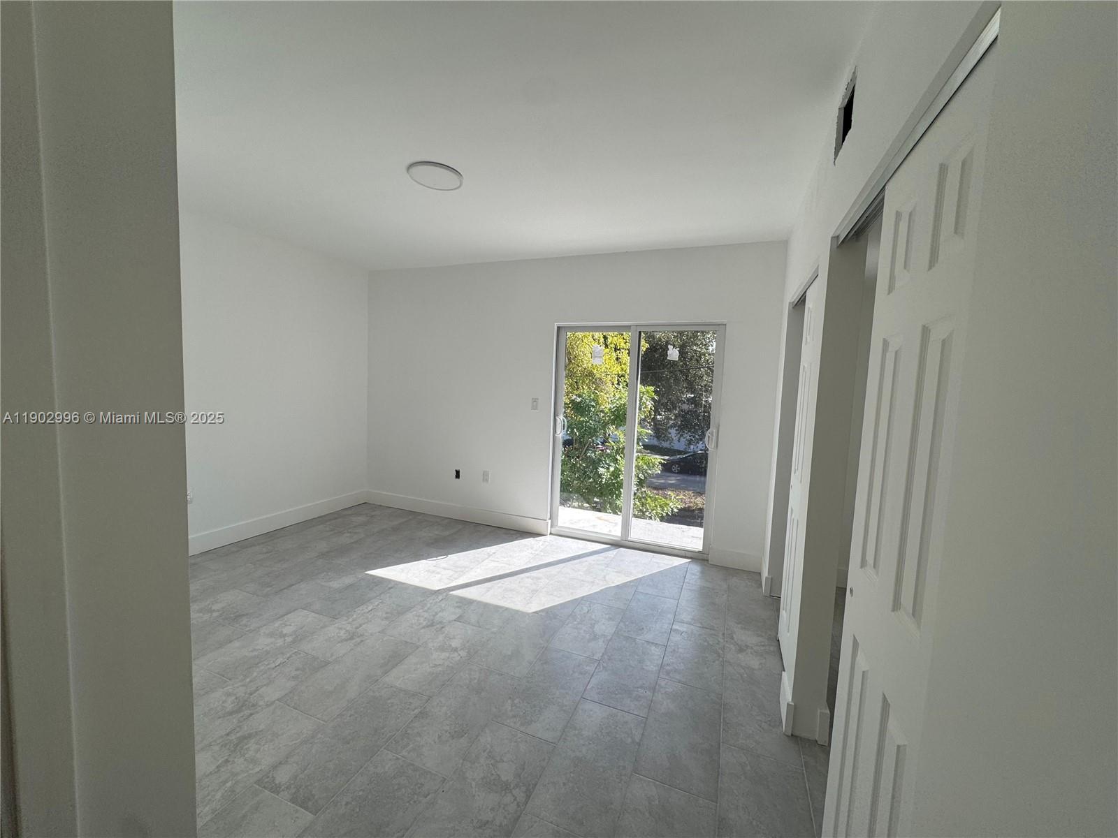 147 Northwest 59th Street, Unit 303 Miami, FL 33127 - Photo 7 of 13 a view of an empty room with a window
