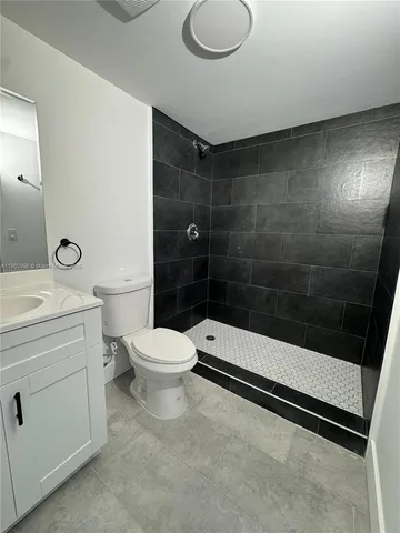 a bathroom with a toilet a sink and shower