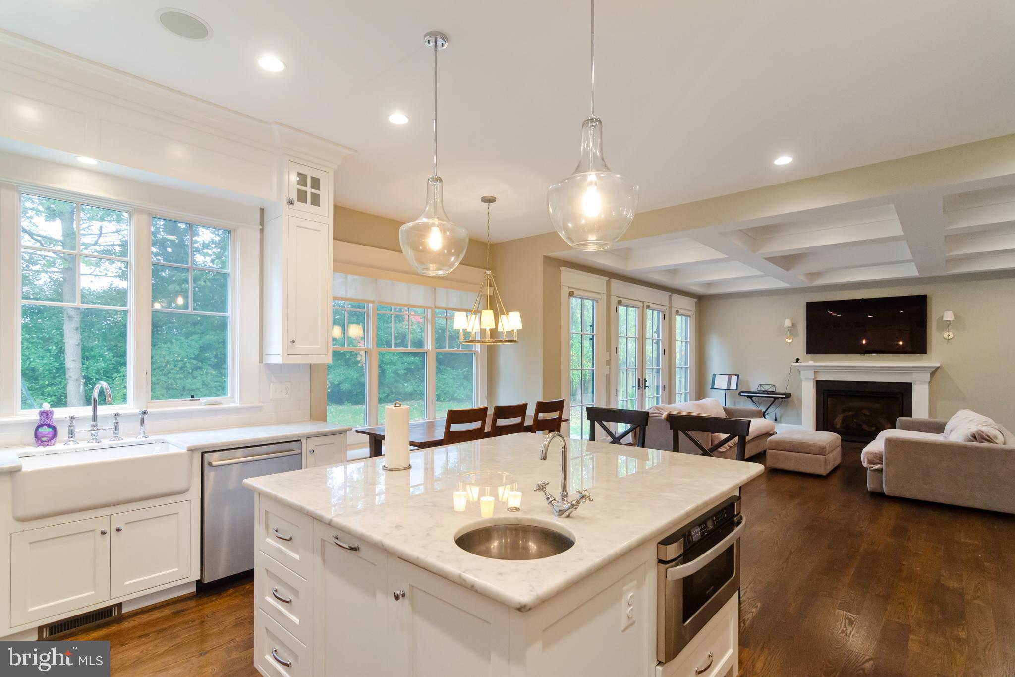 6801 Danforth Street McLean, VA 22101 - Photo 7 of 29 a kitchen with kitchen island a sink a counter space and living room view