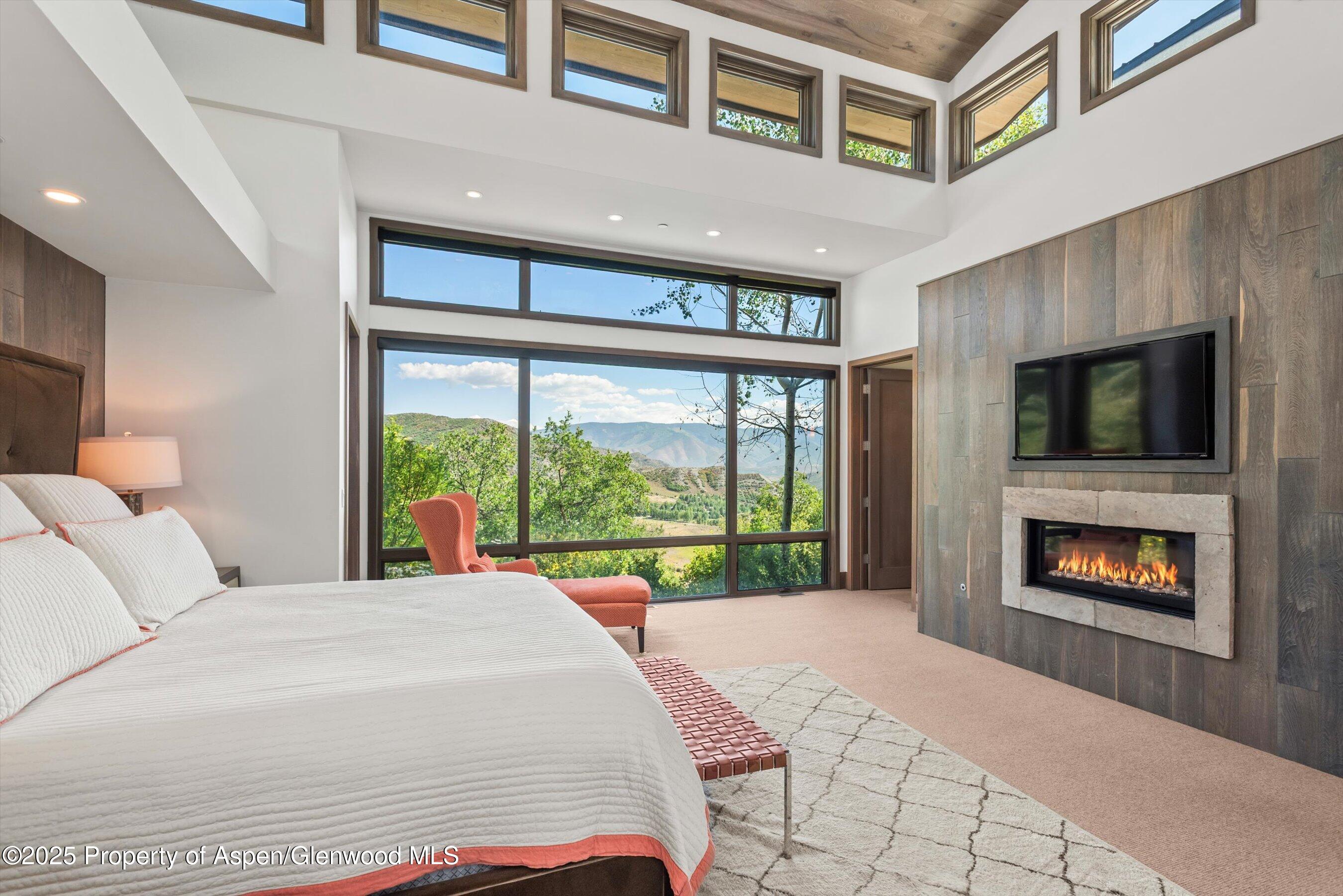 272 Oak Ridge Road Snowmass Village, CO 81615 - Photo 15 of 54 a bedroom with a bed and a fireplace