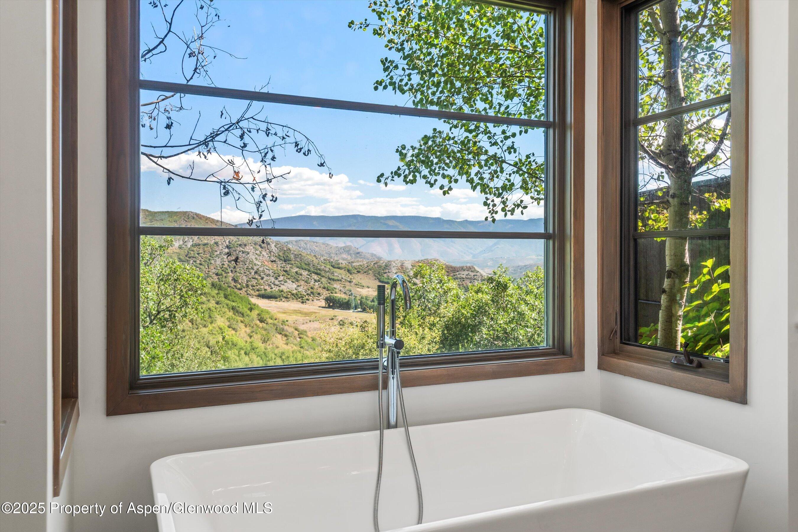 272 Oak Ridge Road Snowmass Village, CO 81615 - Photo 17 of 54 a white bath tub sitting in front of a window