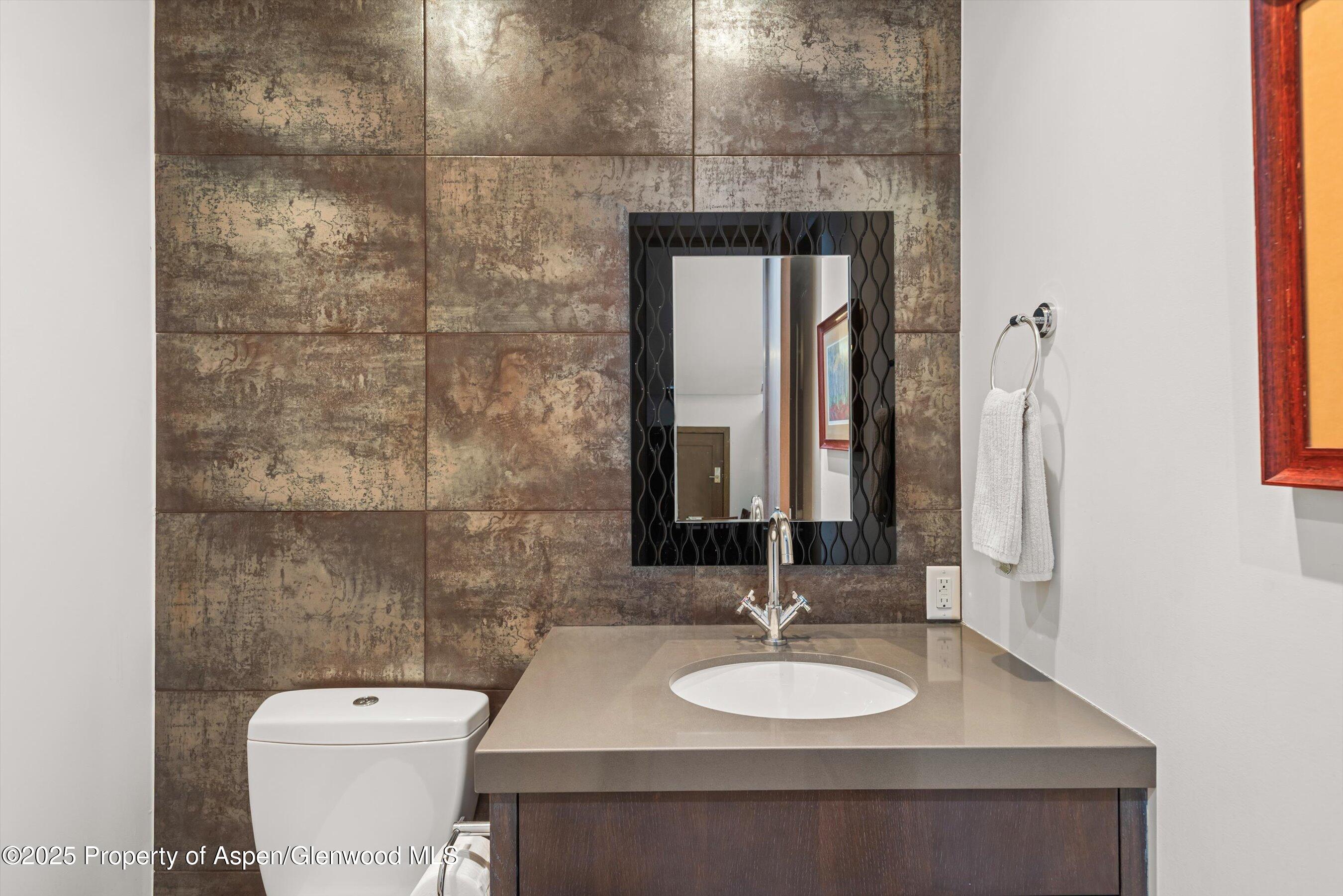 272 Oak Ridge Road Snowmass Village, CO 81615 - Photo 24 of 54 a bathroom with a granite countertop sink a toilet and a mirror