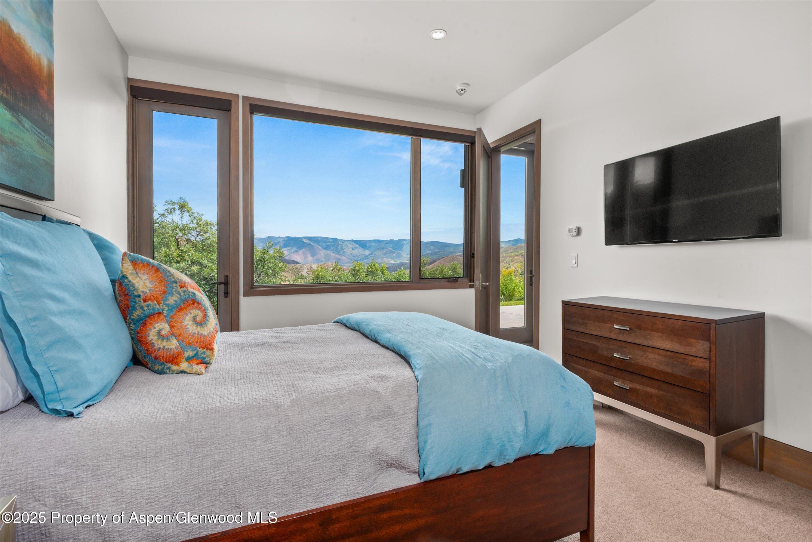 272 Oak Ridge Road Snowmass Village, CO 81615 - Photo 27 of 54 a bedroom with a bed and a flat screen tv