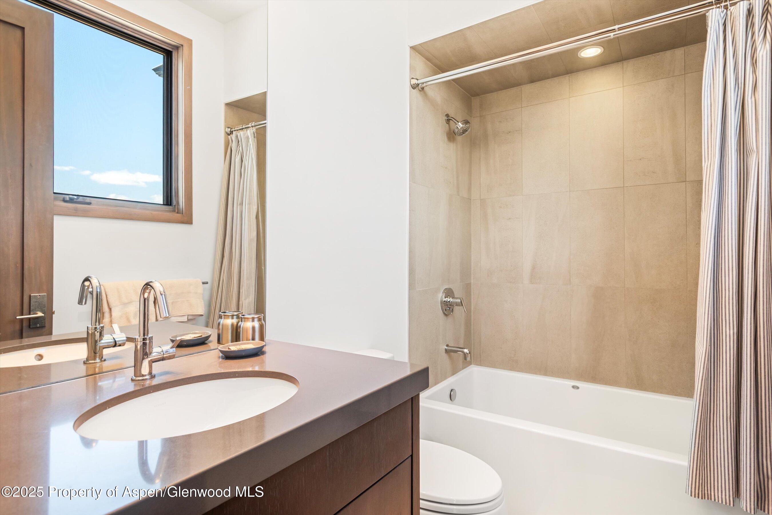 272 Oak Ridge Road Snowmass Village, CO 81615 - Photo 31 of 54 a bathroom with a granite countertop sink and a mirror
