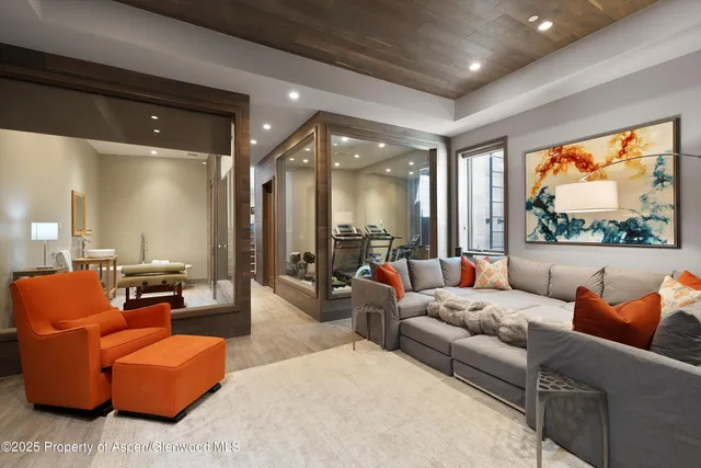 a room with gym equipment and a chandelier