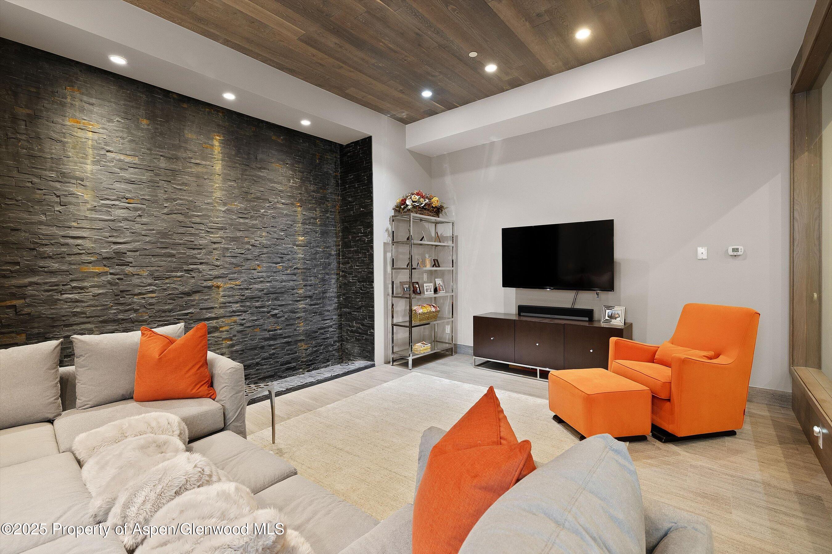 272 Oak Ridge Road Snowmass Village, CO 81615 - Photo 33 of 54 a living room with furniture and a flat screen tv