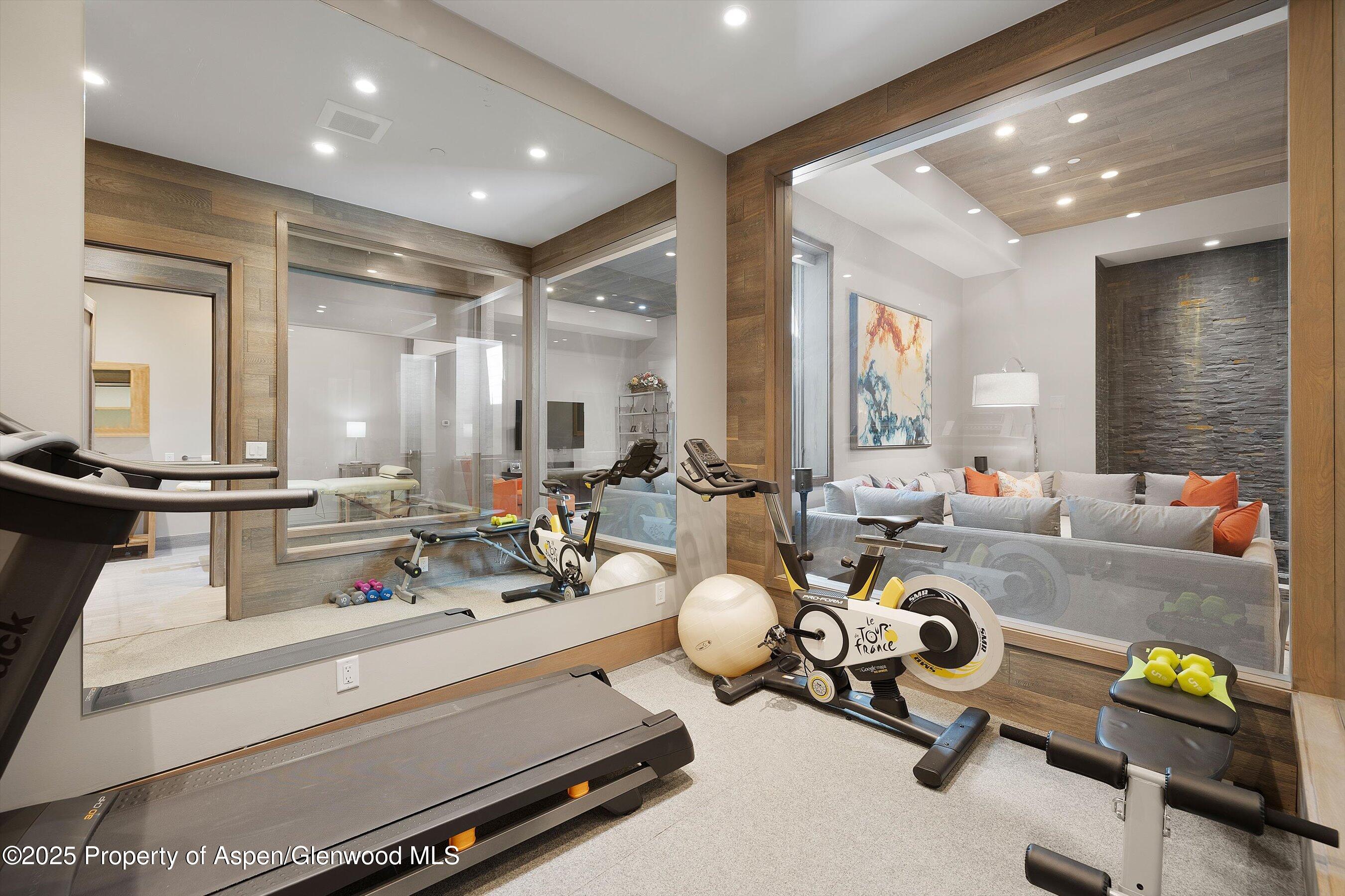 272 Oak Ridge Road Snowmass Village, CO 81615 - Photo 34 of 54 a room with gym equipment and a chandelier