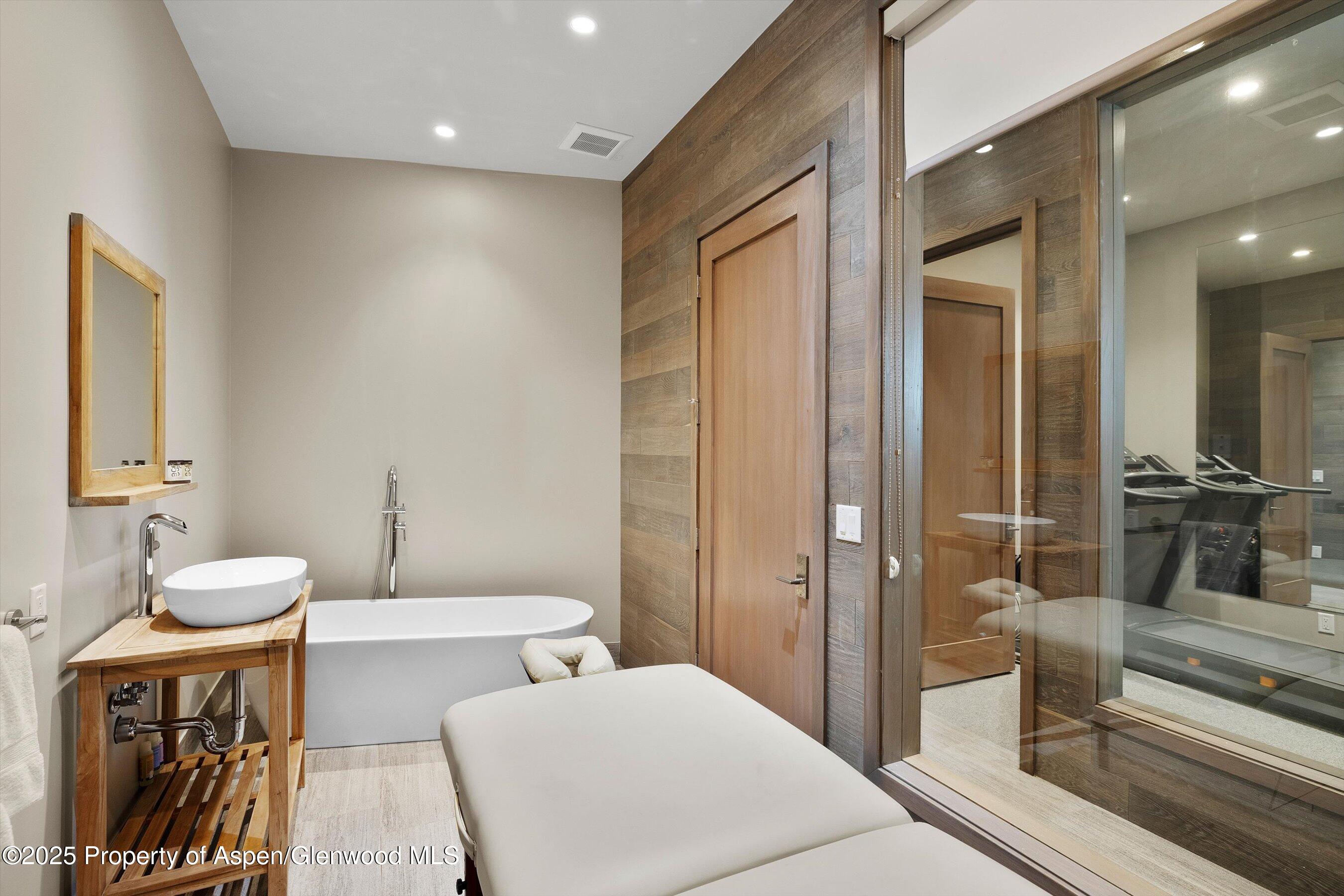272 Oak Ridge Road Snowmass Village, CO 81615 - Photo 35 of 54 a spacious bathroom with a double vanity sink and a mirror