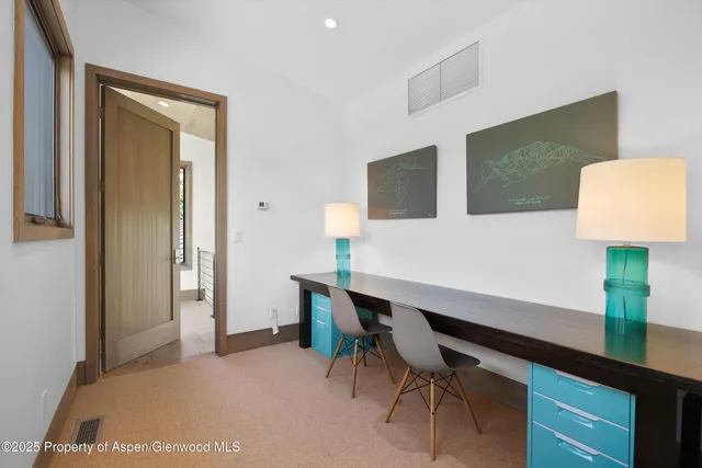 a large bedroom with a bed and large windows