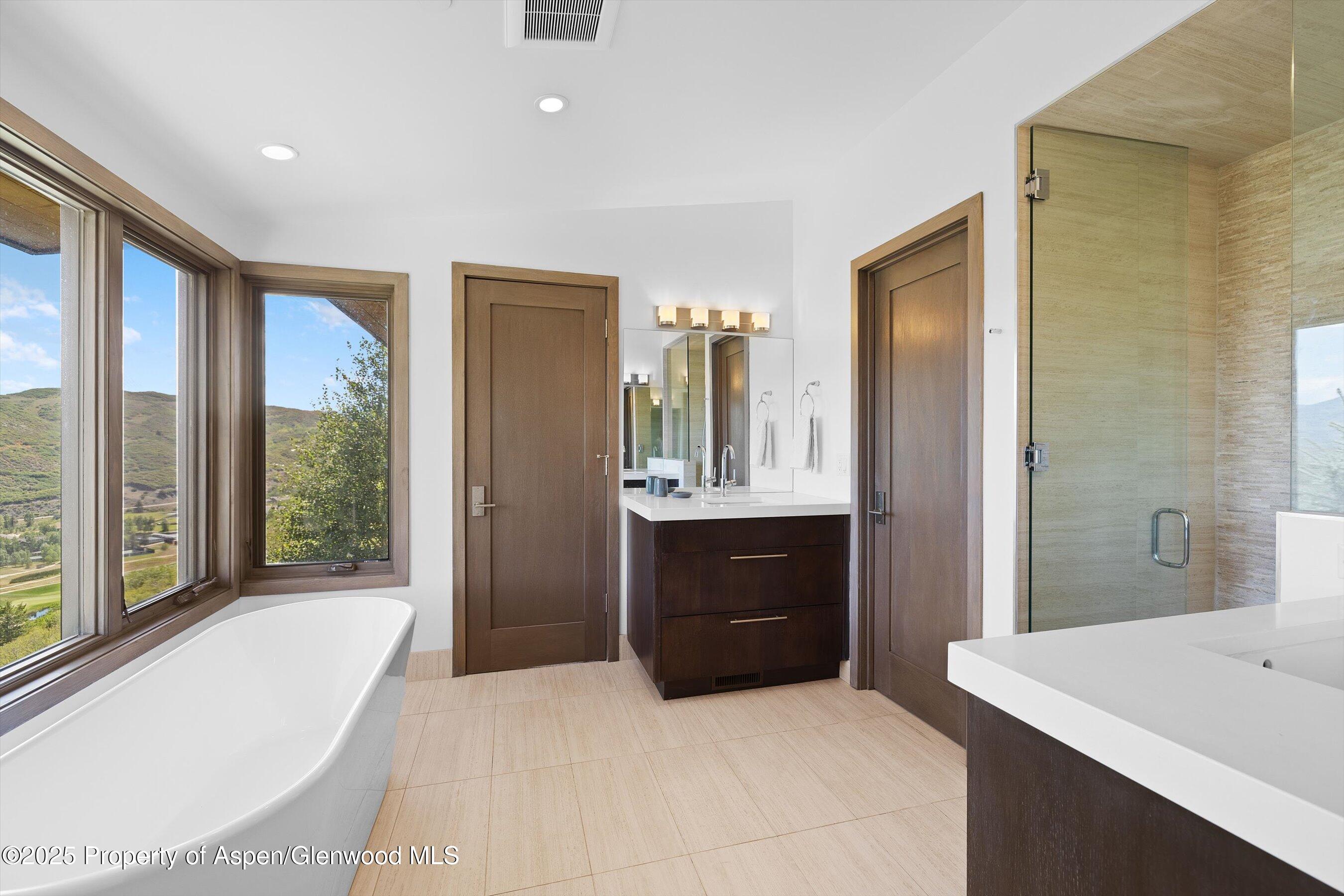 272 Oak Ridge Road Snowmass Village, CO 81615 - Photo 39 of 54 a spacious bathroom with a tub sink and mirror