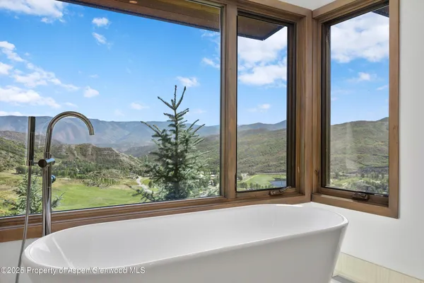 a balcony with wooden floor and outdoor seating