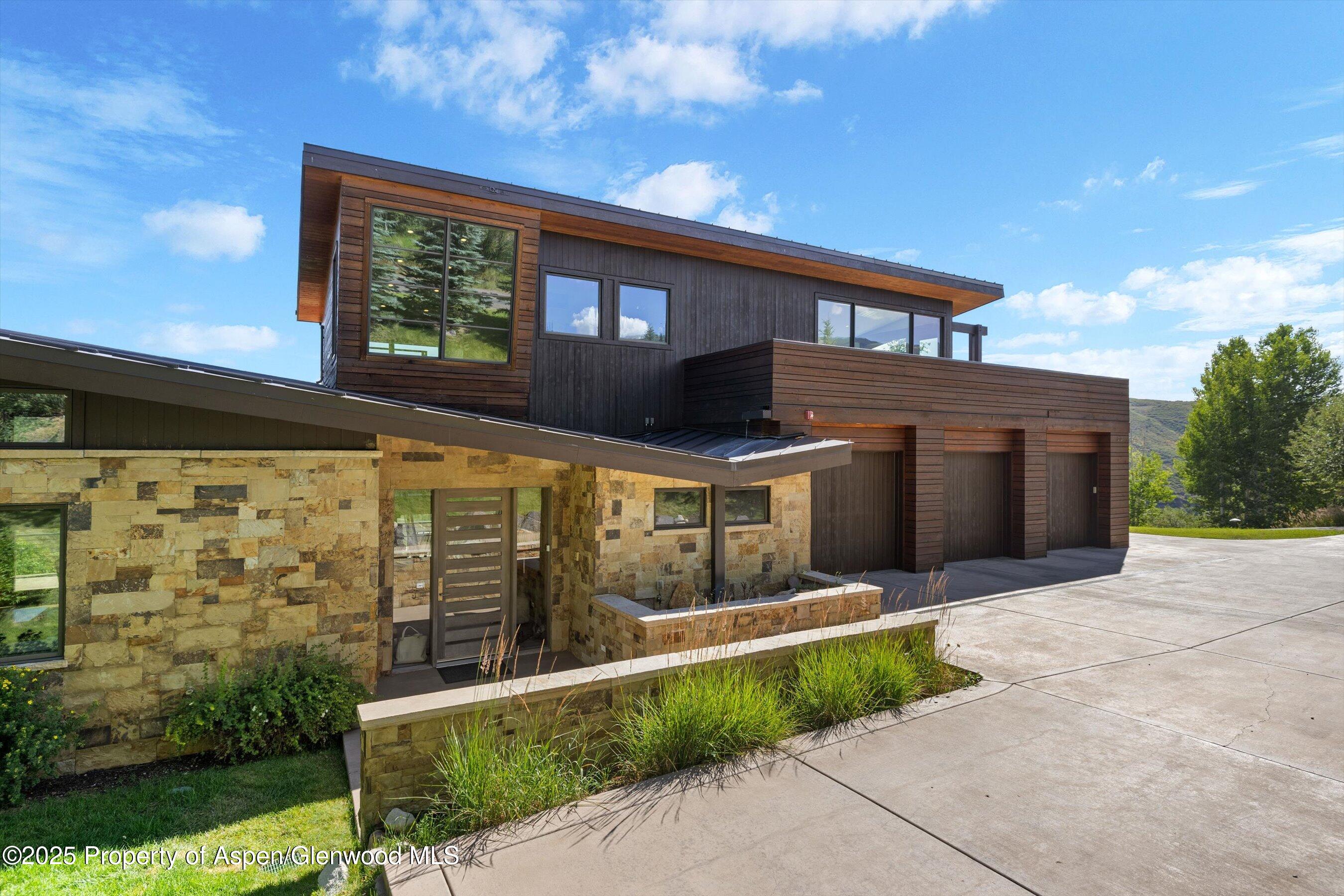 272 Oak Ridge Road Snowmass Village, CO 81615 - Photo 4 of 54 a front view of a house with a yard