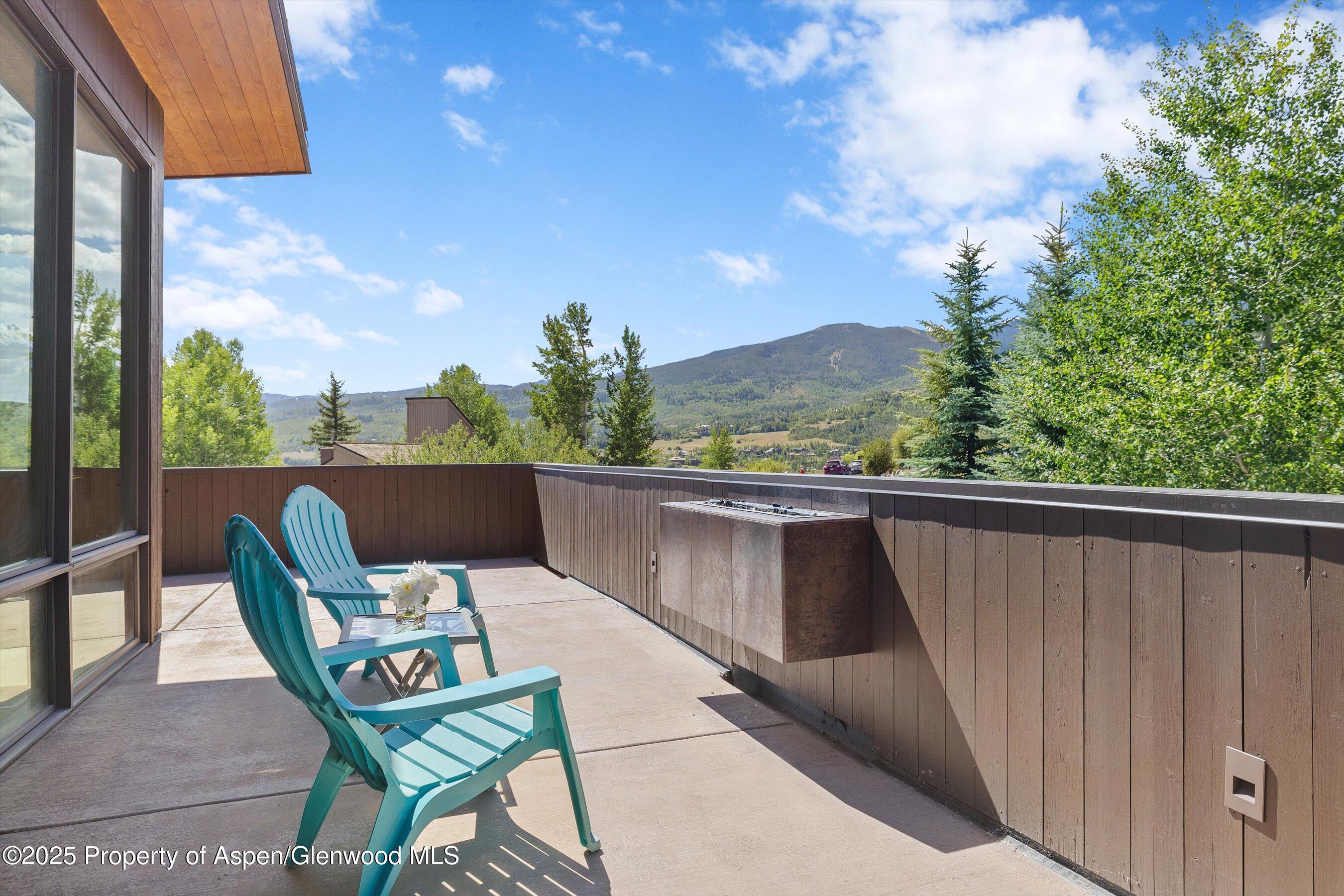 272 Oak Ridge Road Snowmass Village, CO 81615 - Photo 42 of 54 a balcony with wooden floor and outdoor seating