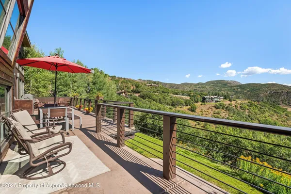 a view of a chairs and table in patio